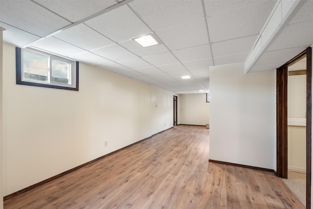 303 Sharon Ct, Anaconda, MT 59711 - below grade area with light wood-style flooring, baseboards, and a paneled ceiling