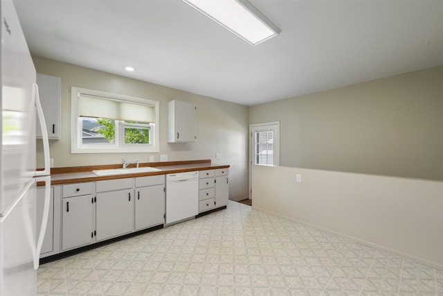 303 Sharon Ct, Anaconda, MT 59711 - kitchen featuring white appliances, a sink, white cabinets, baseboards, and recessed lighting