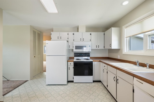 303 Sharon Ct, Anaconda, MT 59711 - kitchen with white appliances, a sink, light floors, white cabinets, and recessed lighting