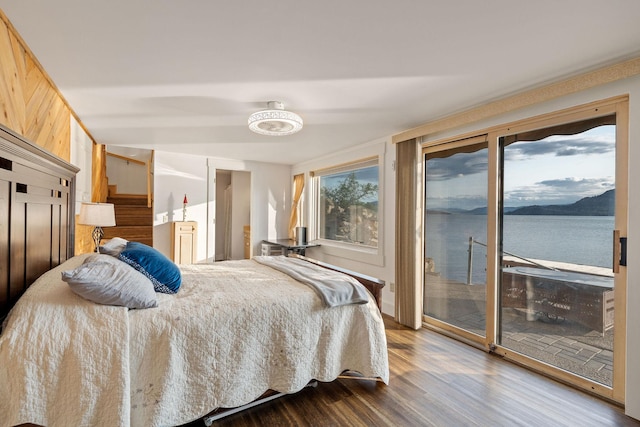 21347 Hydeaway Rd, Rollins, MT 59931 - bedroom featuring access to outside, dark wood-style floors, and a water view