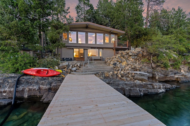 21347 Hydeaway Rd, Rollins, MT 59931 - back of property featuring stucco siding, a water view, and stairs