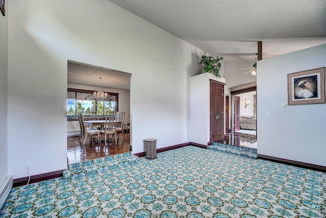 1644 Gold Rush Ave, Helena, MT 59601 - spare room featuring a ceiling fan, a textured ceiling, a chandelier, baseboards, and vaulted ceiling