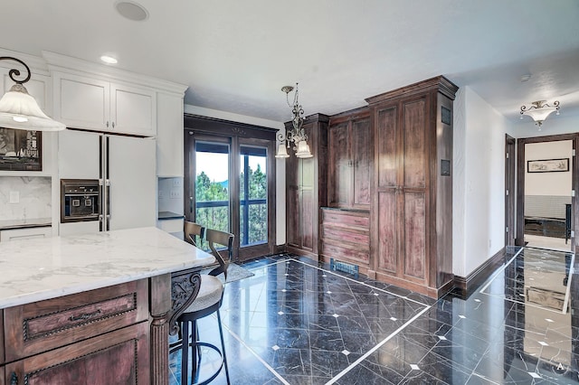 1644 Gold Rush Ave, Helena, MT 59601 - kitchen with baseboards, white refrigerator with ice dispenser, hanging light fixtures, white cabinets, and light stone countertops