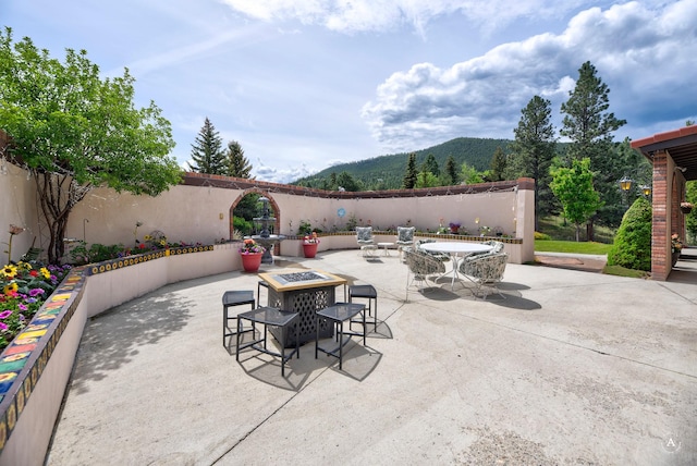 1644 Gold Rush Ave, Helena, MT 59601 - view of patio featuring an outdoor fire pit, a mountain view, and outdoor dining space