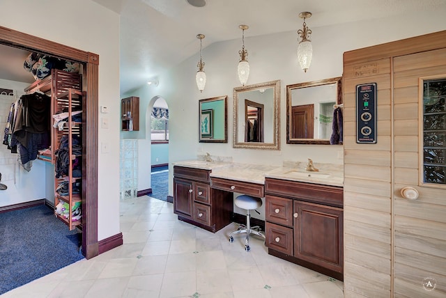 1644 Gold Rush Ave, Helena, MT 59601 - full bathroom with vaulted ceiling, double vanity, a spacious closet, baseboards, and tile patterned floors