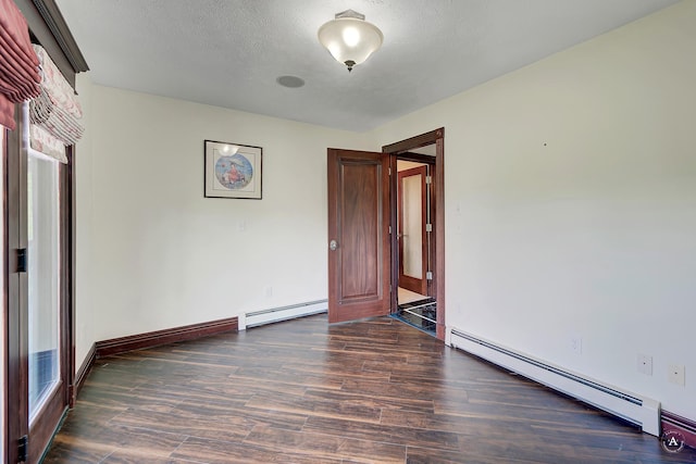 1644 Gold Rush Ave, Helena, MT 59601 - empty room with baseboard heating, dark wood-type flooring, and baseboards