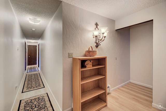 1644 Gold Rush Ave, Helena, MT 59601 - corridor featuring a textured ceiling, light wood-type flooring, and baseboards