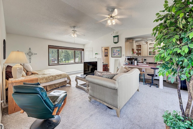 1644 Gold Rush Ave, Helena, MT 59601 - bedroom featuring lofted ceiling, a baseboard heating unit, a textured ceiling, ceiling fan, and light colored carpet