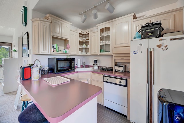 1644 Gold Rush Ave, Helena, MT 59601 - kitchen featuring white appliances, a sink, open shelves, a peninsula, and a kitchen bar
