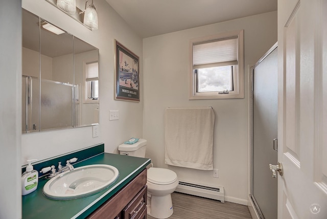 1644 Gold Rush Ave, Helena, MT 59601 - bathroom with a baseboard radiator, a stall shower, vanity, toilet, and wood finished floors