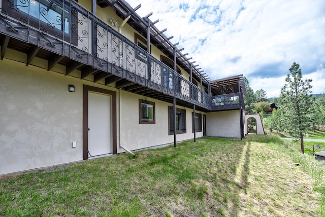 1644 Gold Rush Ave, Helena, MT 59601 - back of house featuring stucco siding and a lawn