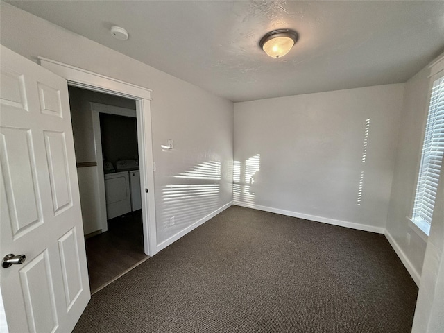 506 1st Ave E Unit A, B, C, Eureka, MT 59917 - spare room with washer and dryer, a smoke detector, dark carpet, and baseboards