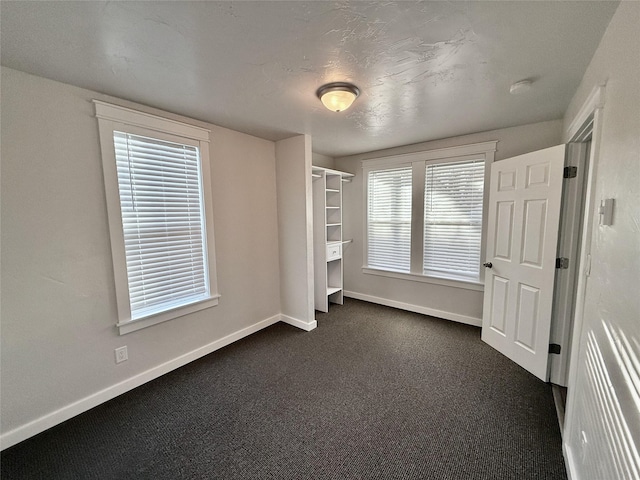 506 1st Ave E Unit A, B, C, Eureka, MT 59917 - unfurnished bedroom with baseboards and dark carpet