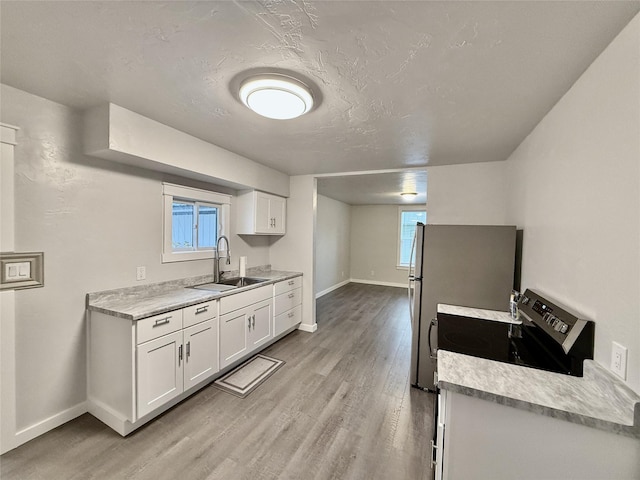 506 1st Ave E Unit A, B, C, Eureka, MT 59917 - kitchen with a sink, light wood-style flooring, and baseboards
