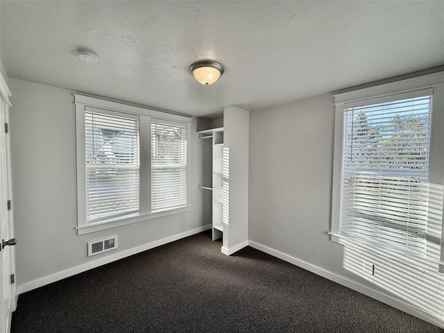 506 1st Ave E Unit A, B, C, Eureka, MT 59917 - unfurnished bedroom featuring baseboards and dark carpet