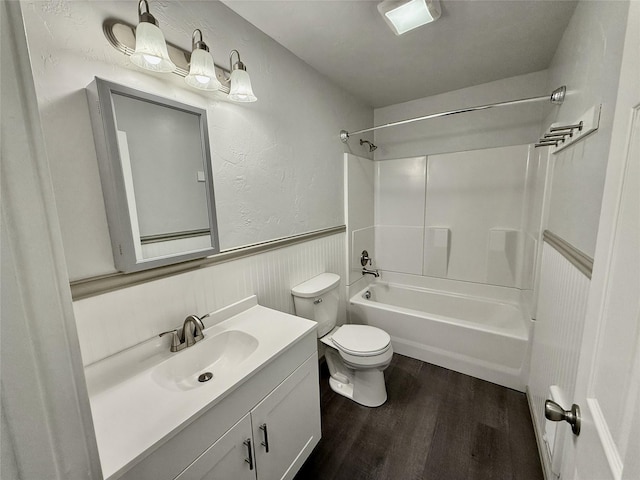 506 1st Ave E Unit A, B, C, Eureka, MT 59917 - bathroom featuring wood finished floors, bathtub / shower combination, toilet, vanity, and a wainscoted wall