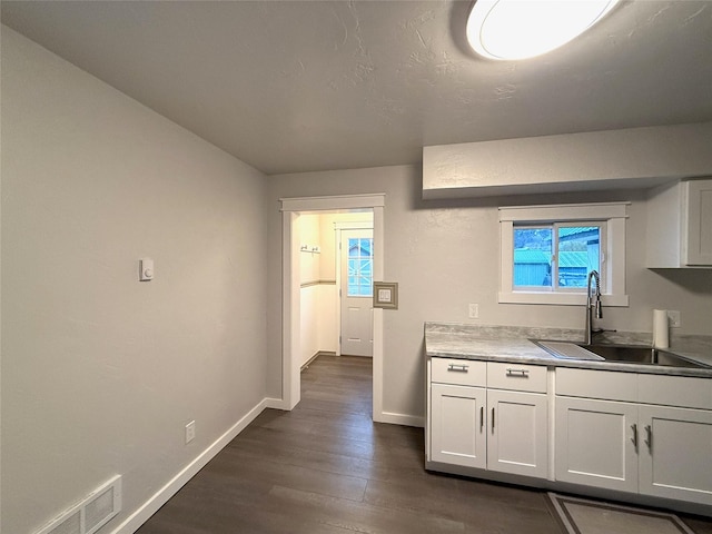 506 1st Ave E Unit A, B, C, Eureka, MT 59917 - kitchen with a sink, dark wood finished floors, baseboards, and white cabinets