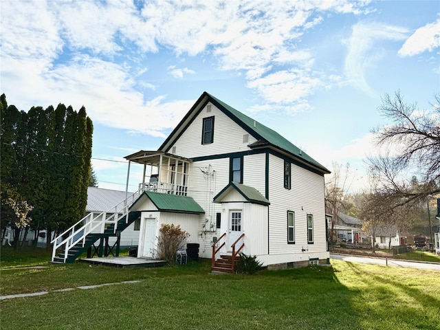 506 1st Ave E Unit A, B, C, Eureka, MT 59917 - back of house with a lawn, stairs, a balcony, and entry steps