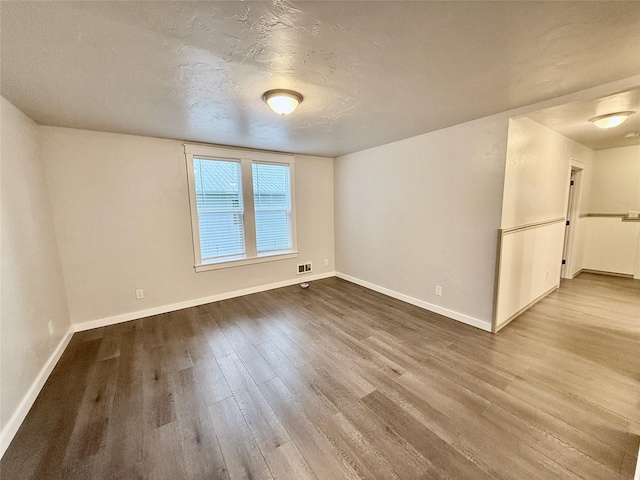 506 1st Ave E Unit A, B, C, Eureka, MT 59917 - empty room with dark wood-style floors, baseboards, and a textured ceiling