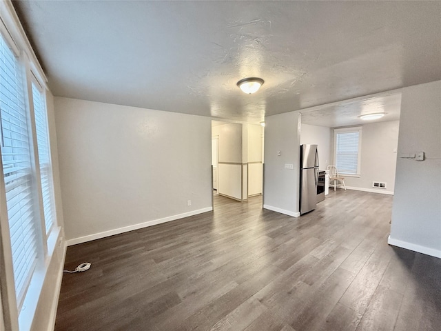 506 1st Ave E Unit A, B, C, Eureka, MT 59917 - unfurnished living room featuring dark wood-type flooring and baseboards