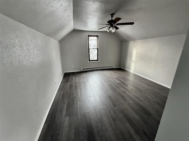 506 1st Ave E Unit A, B, C, Eureka, MT 59917 - additional living space with a baseboard heating unit, vaulted ceiling, a ceiling fan, dark wood-style floors, and a textured ceiling