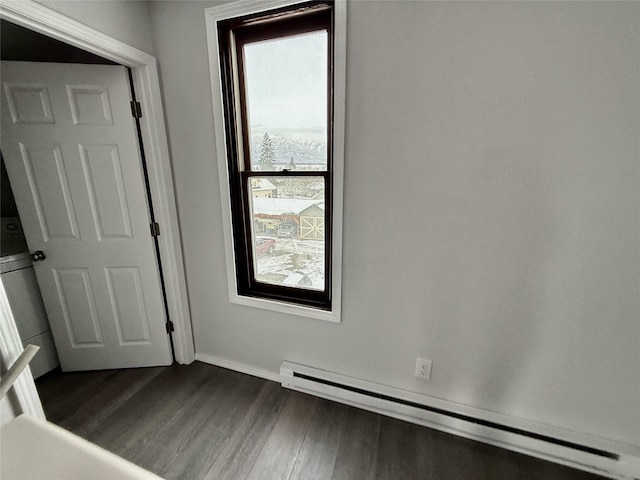 506 1st Ave E Unit A, B, C, Eureka, MT 59917 - unfurnished room with baseboard heating, dark wood-type flooring, and baseboards