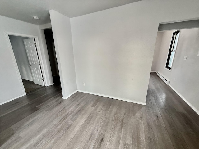 506 1st Ave E Unit A, B, C, Eureka, MT 59917 - spare room with wood finished floors, baseboard heating, baseboards, and a smoke detector