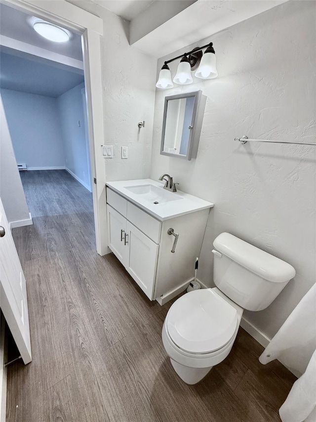 506 1st Ave E Unit A, B, C, Eureka, MT 59917 - half bathroom with wood finished floors, vanity, toilet, and baseboards