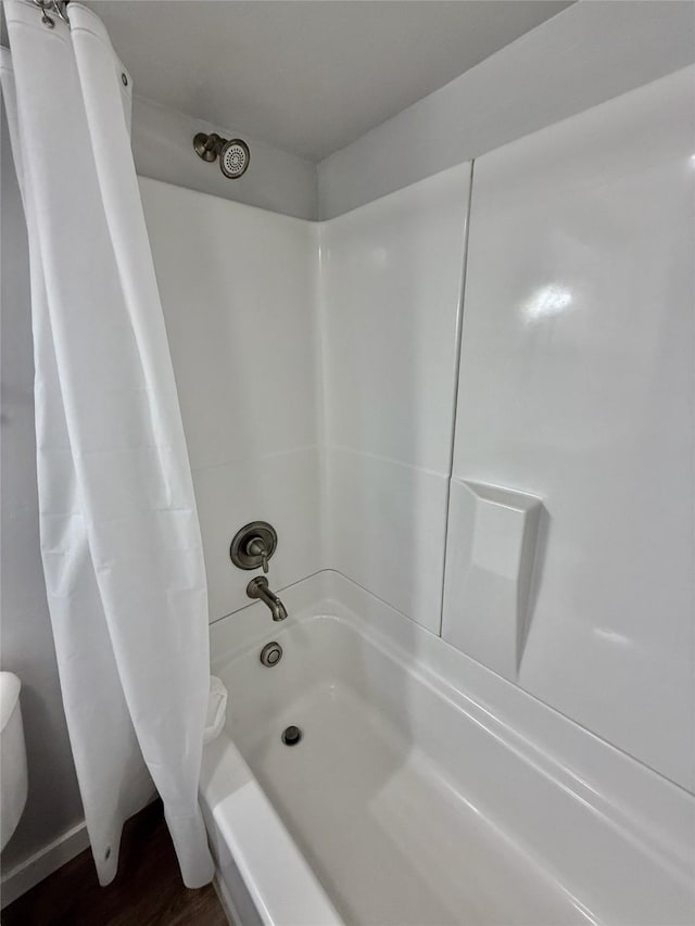506 1st Ave E Unit A, B, C, Eureka, MT 59917 - bathroom with shower / tub combo with curtain, wood finished floors, and toilet