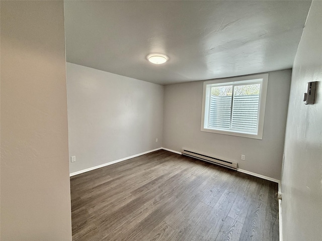 506 1st Ave E Unit A, B, C, Eureka, MT 59917 - unfurnished room featuring a baseboard heating unit, wood finished floors, and baseboards