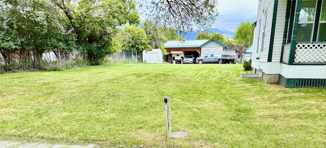 506 1st Ave E Unit A, B, C, Eureka, MT 59917 - view of grassy yard featuring an outdoor structure and a carport