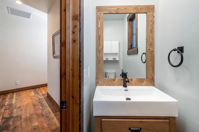 45331 Turnquist Rd, Ronan, MT 59864 - bathroom with wood finished floors, vanity, toilet, and baseboards
