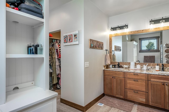45331 Turnquist Rd, Ronan, MT 59864 - full bathroom featuring double vanity, a spacious closet, and baseboards