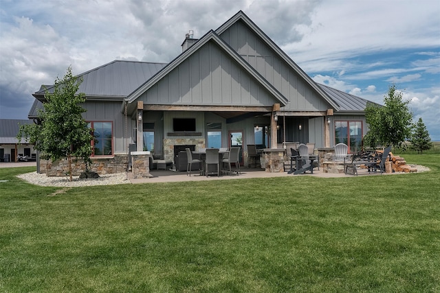 45331 Turnquist Rd, Ronan, MT 59864 - rear view of house featuring a patio area, a chimney, a yard, and board and batten siding