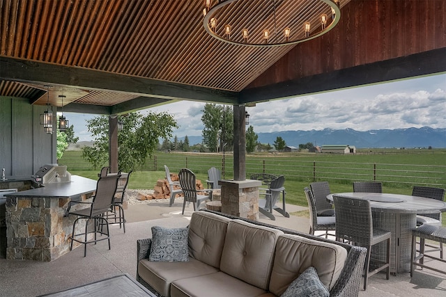 45331 Turnquist Rd, Ronan, MT 59864 - view of patio featuring an outdoor living space, outdoor dining space, a mountain view, a grill, and a view of countryside