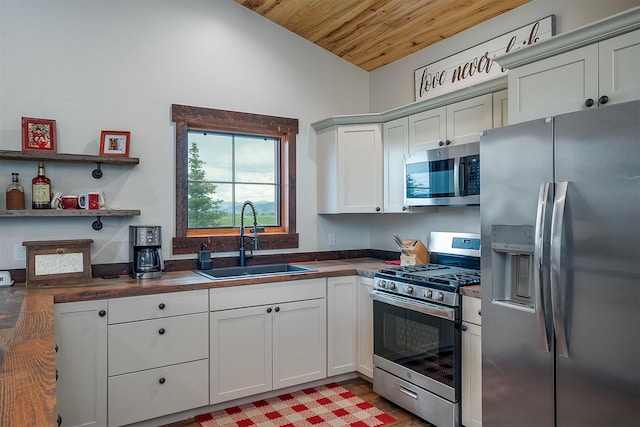 45331 Turnquist Rd, Ronan, MT 59864 - kitchen with appliances with stainless steel finishes, a sink, wooden ceiling, lofted ceiling, and wood counters
