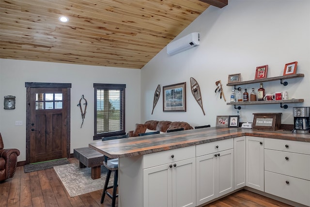 45331 Turnquist Rd, Ronan, MT 59864 - kitchen featuring wood counters, wood ceiling, open floor plan, a wall mounted air conditioner, and vaulted ceiling