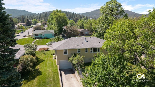 1302 Highland St, Helena, MT 59601 - aerial view of property and surrounding area featuring a mountainous background and a heavily wooded area
