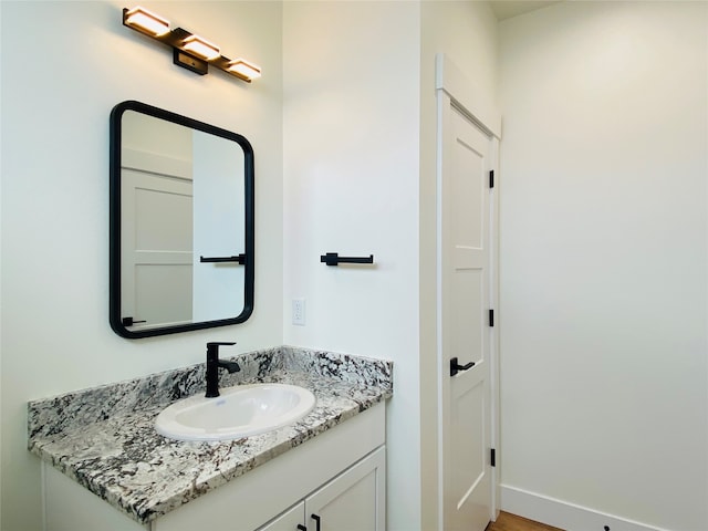 5341A Remington Dr Unit A, Missoula, MT 59808 - bathroom with vanity, baseboards, and wood finished floors