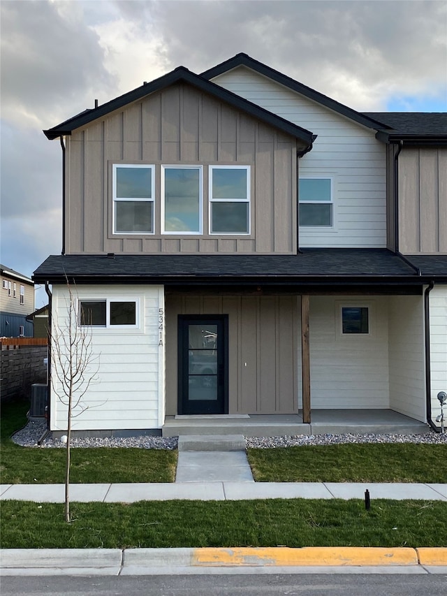 5341A Remington Dr Unit A, Missoula, MT 59808 - view of front of property featuring board and batten siding, cooling unit, a porch, and a front yard