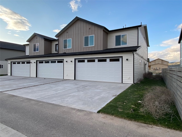 5341A Remington Dr Unit A, Missoula, MT 59808 - view of front of house with an attached garage, concrete driveway, and board and batten siding