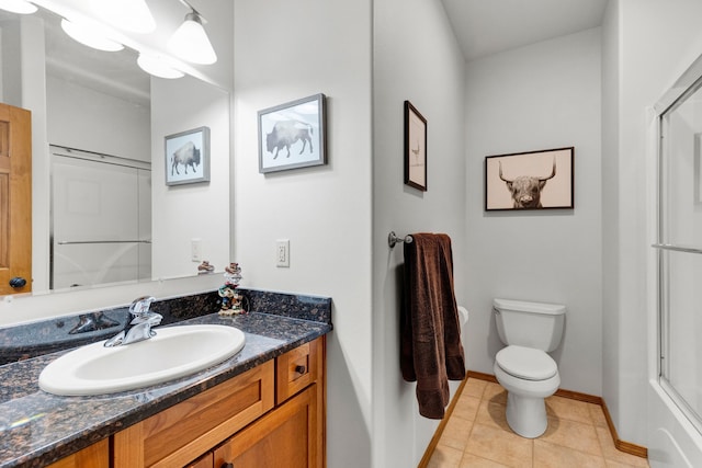 1618 Creekside Dr, Stevensville, MT 59870 - bathroom featuring toilet, vanity, baseboards, and tile patterned floors