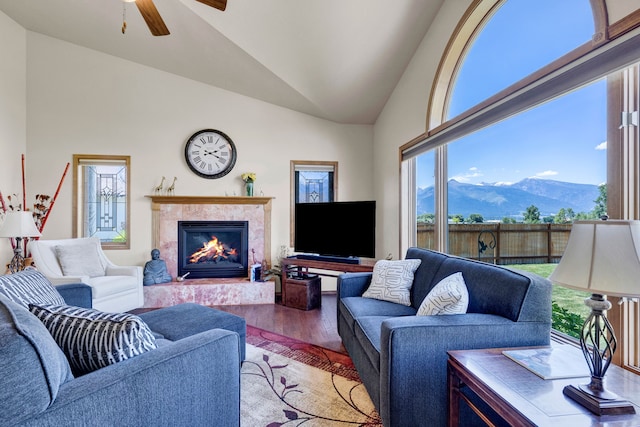 1618 Creekside Dr, Stevensville, MT 59870 - living area with wood finished floors, vaulted ceiling, a tile fireplace, and a ceiling fan