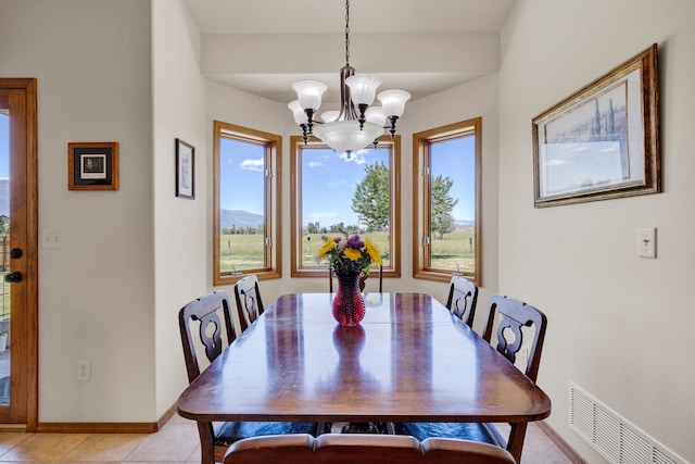1618 Creekside Dr, Stevensville, MT 59870 - dining area with a chandelier, baseboards, light tile patterned flooring, and a mountain view