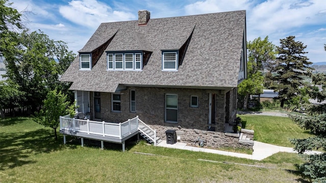 860 Hiawatha St, Helena, MT 59601 - back of house with a deck, a lawn, roof with shingles, a chimney, and stone siding