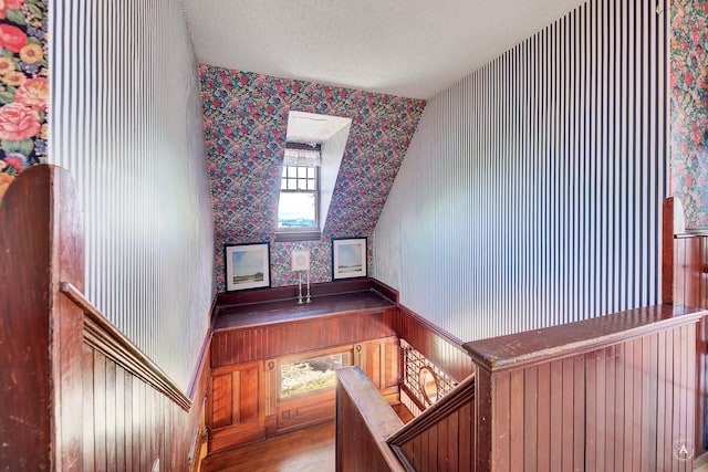 860 Hiawatha St, Helena, MT 59601 - staircase with wallpapered walls, a textured ceiling, plenty of natural light, and wood finished floors