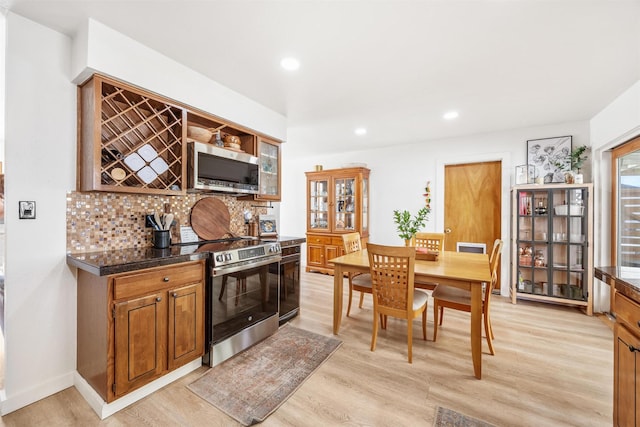 3301 Albany Ave, Butte, MT 59701 - kitchen with stainless steel appliances, light wood-style flooring, tasteful backsplash, recessed lighting, and brown cabinetry