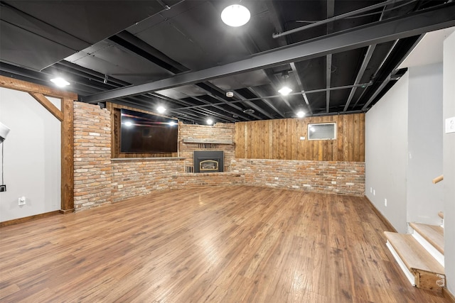 3301 Albany Ave, Butte, MT 59701 - finished basement with wood finished floors, brick wall, stairway, and a fireplace