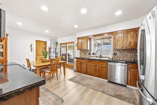 3301 Albany Ave, Butte, MT 59701 - kitchen featuring stainless steel appliances, dark countertops, light wood-style floors, brown cabinets, and recessed lighting