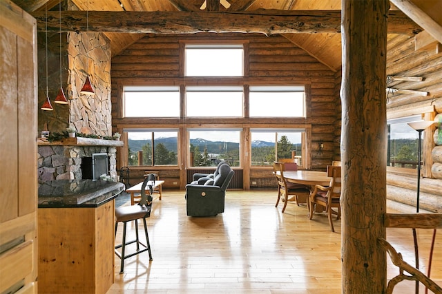 30 Douglas Lee Ln, Anaconda, MT 59711 - living room featuring log walls, a wooden ceiling with exposed beams, high vaulted ceiling, a mountain view, and light wood-style flooring